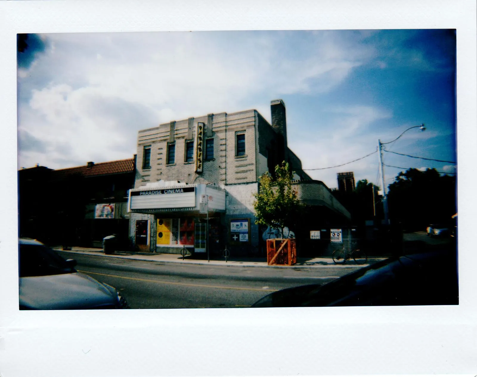 A classic vintage cinema building captured on a sunny day in Toronto, showcasing urban life.